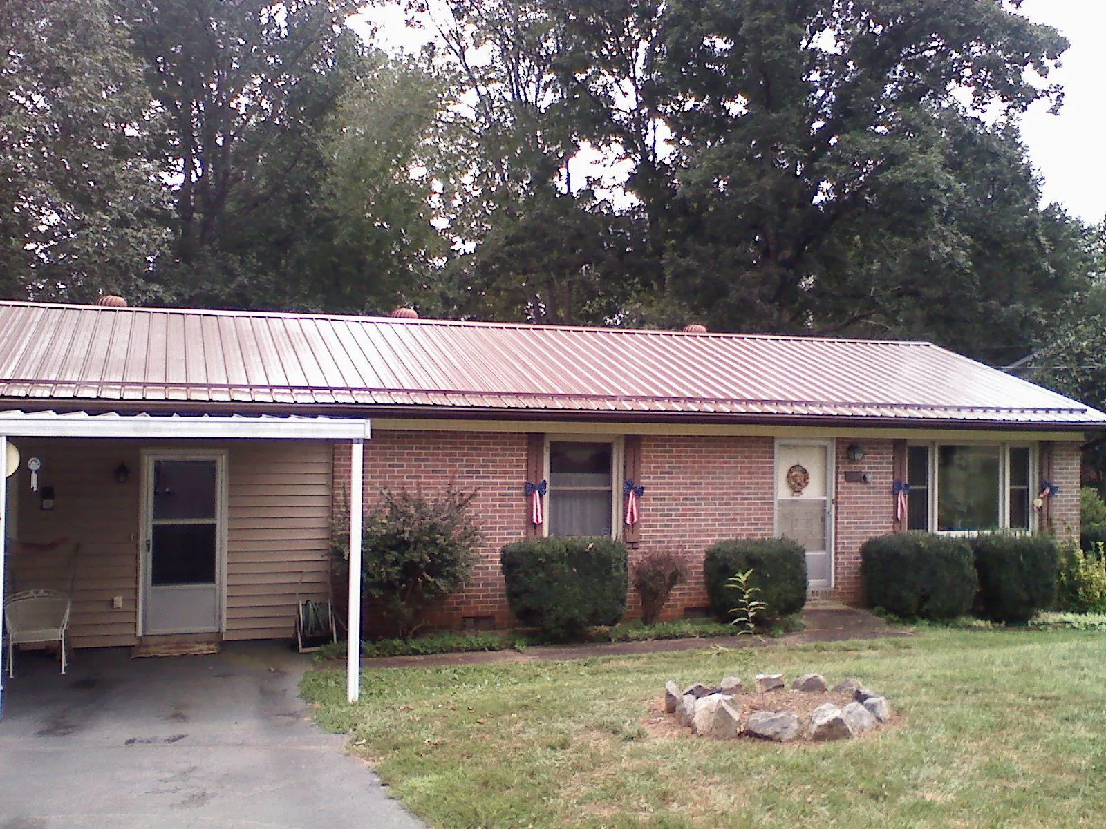 Bronze metal roof and carport on a brick ranch home — Roof Repair work by our crew in Imperial